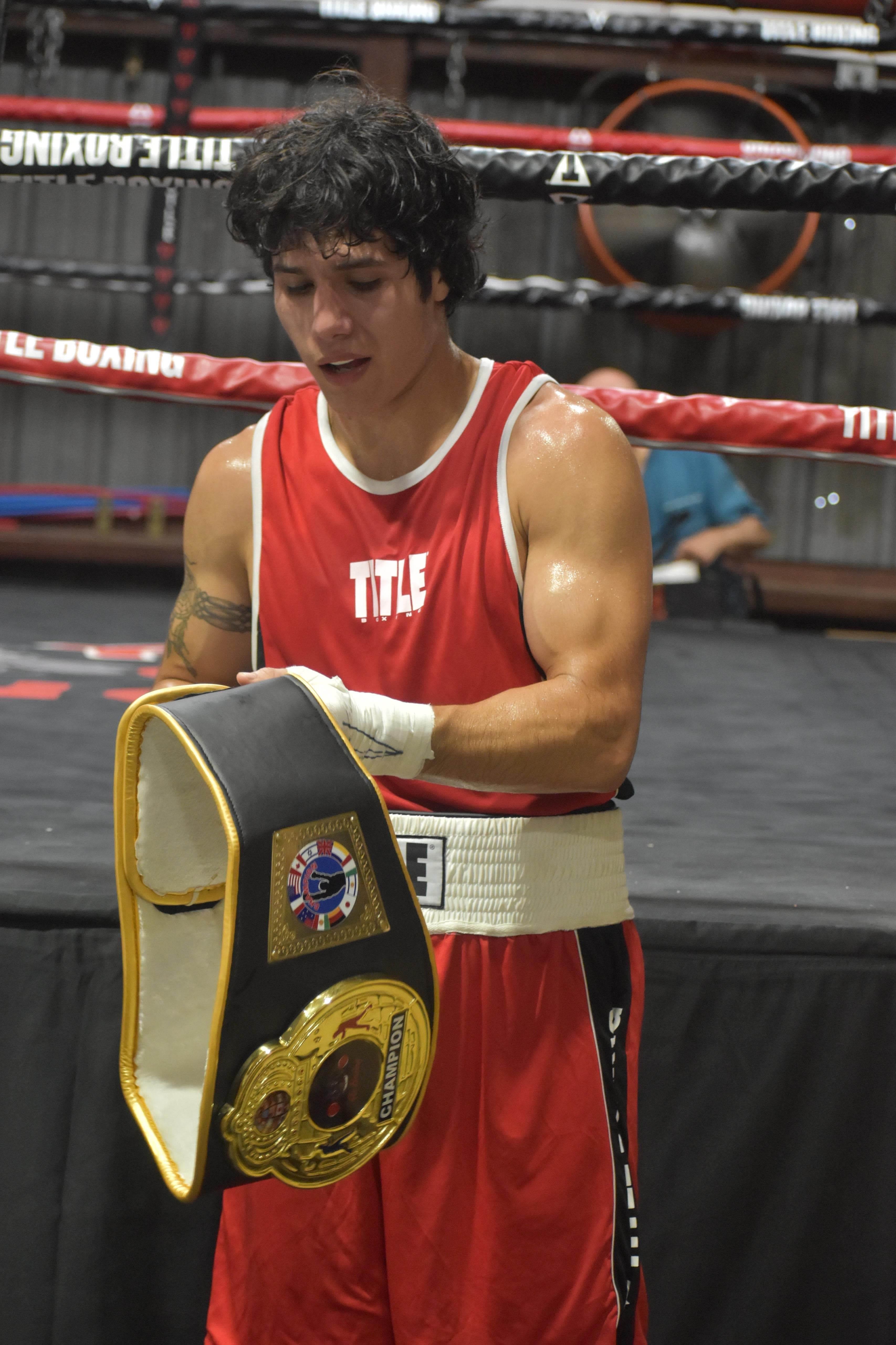 Holding a championship belt after a fight